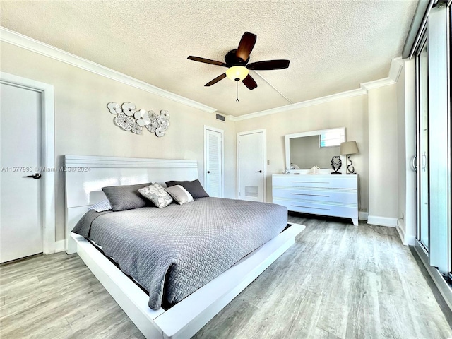 bedroom featuring ornamental molding, light hardwood / wood-style flooring, ceiling fan, and a textured ceiling