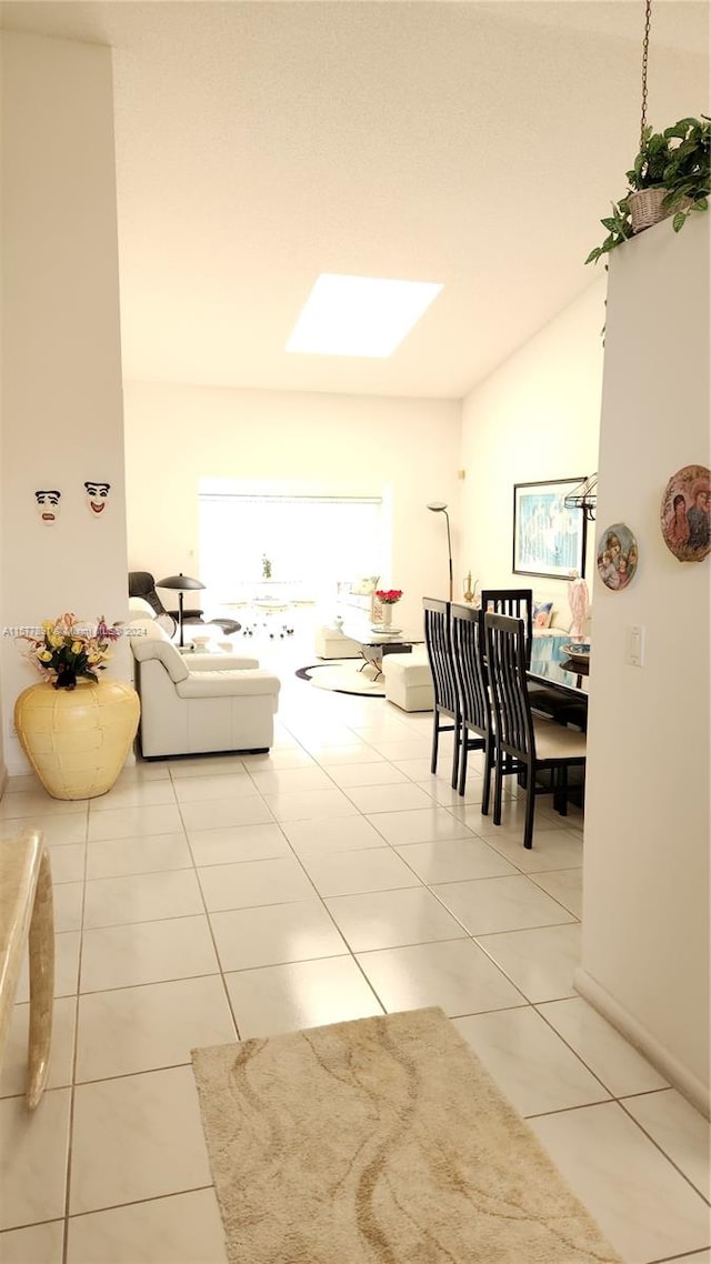 living room with lofted ceiling and tile flooring