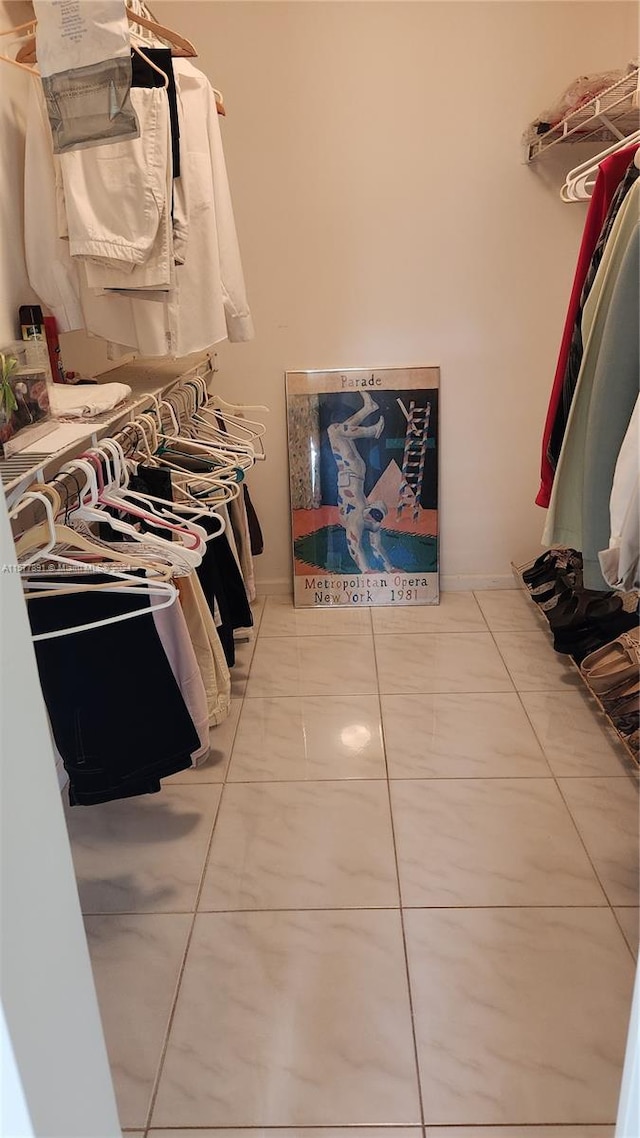 walk in closet featuring tile floors