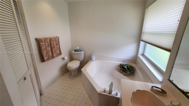 bathroom featuring toilet, tile flooring, and a bath