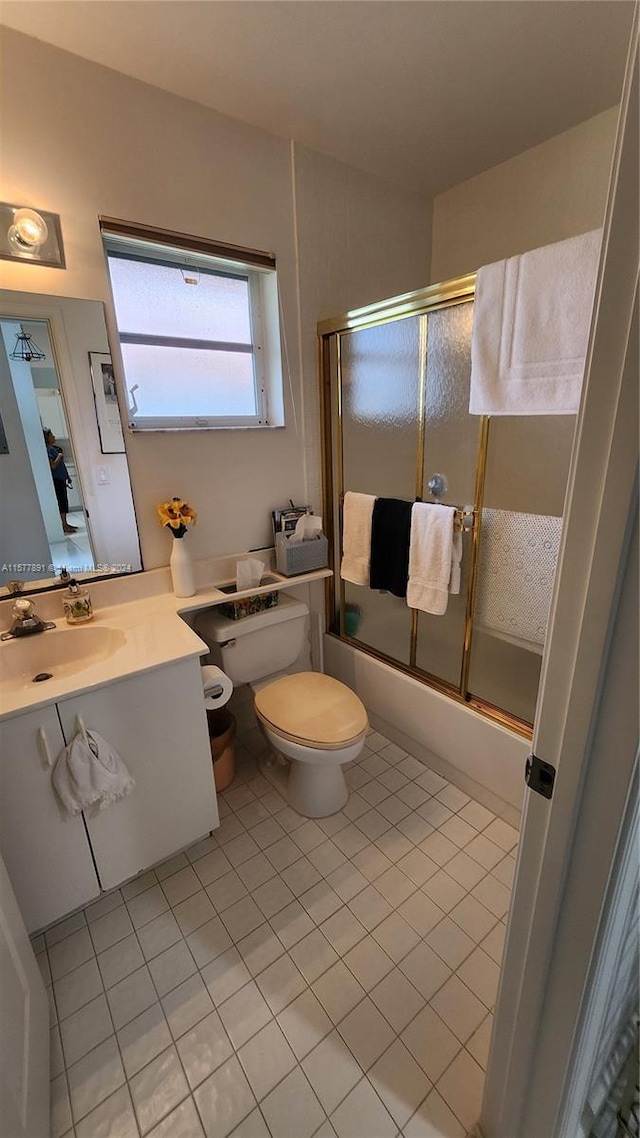 bathroom featuring tile floors, toilet, and large vanity