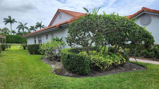 view of side of home featuring a lawn