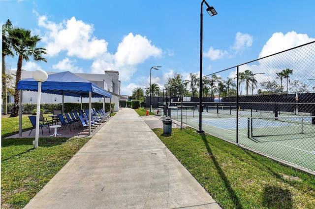 view of sport court featuring a yard