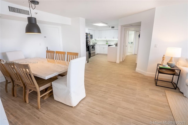 dining space featuring light hardwood / wood-style flooring