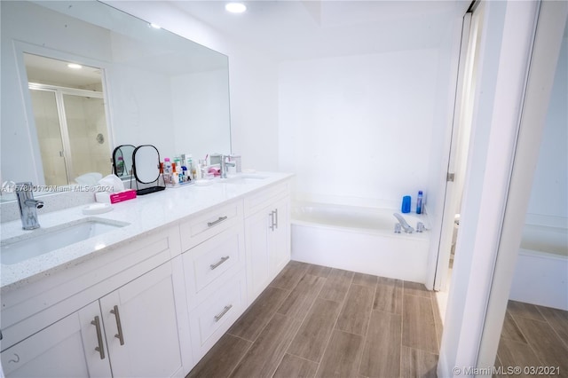 bathroom with plus walk in shower and double sink vanity