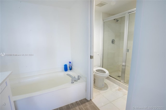 full bathroom with plus walk in shower, vanity, toilet, and tile flooring