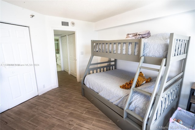 bedroom with a closet and dark wood-type flooring