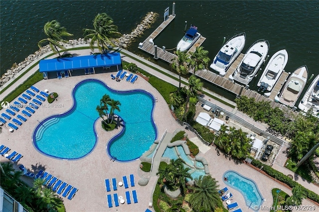 view of swimming pool featuring a water view and a patio