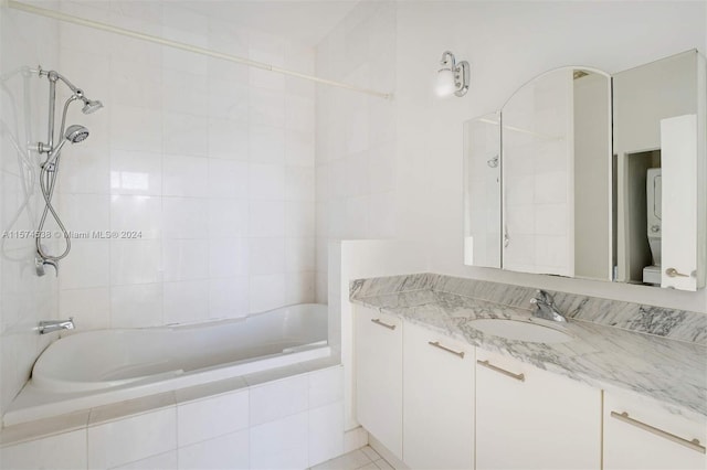 full bathroom featuring vanity with extensive cabinet space, tiled shower / bath combo, and toilet