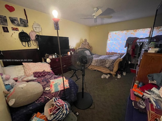 bedroom featuring a textured ceiling, ceiling fan, and carpet