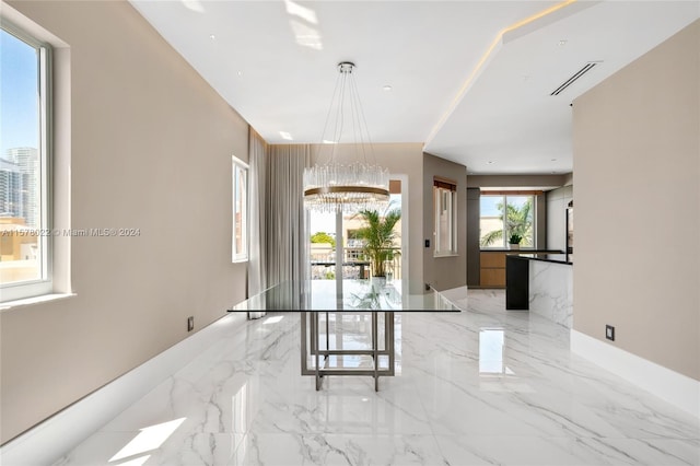 unfurnished dining area with an inviting chandelier