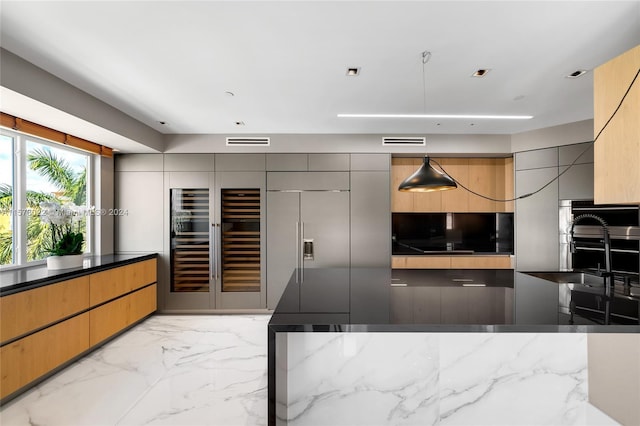 kitchen with pendant lighting, dark stone countertops, and appliances with stainless steel finishes