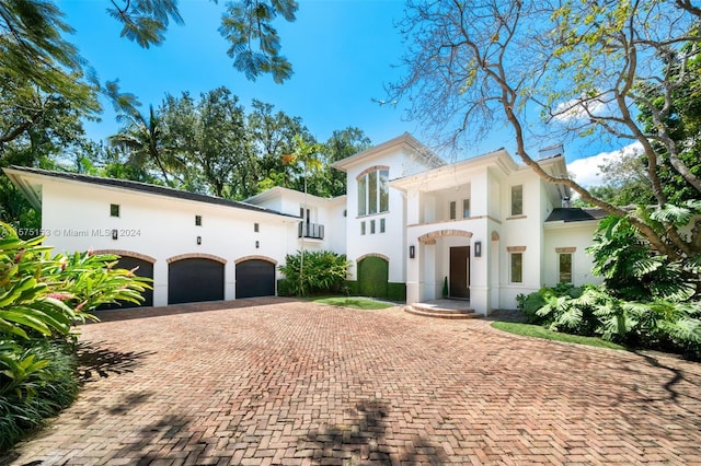 mediterranean / spanish home featuring a garage