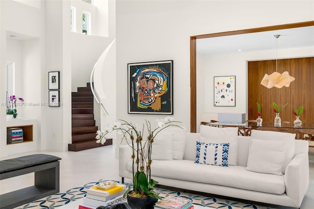 living room with tile floors and a high ceiling