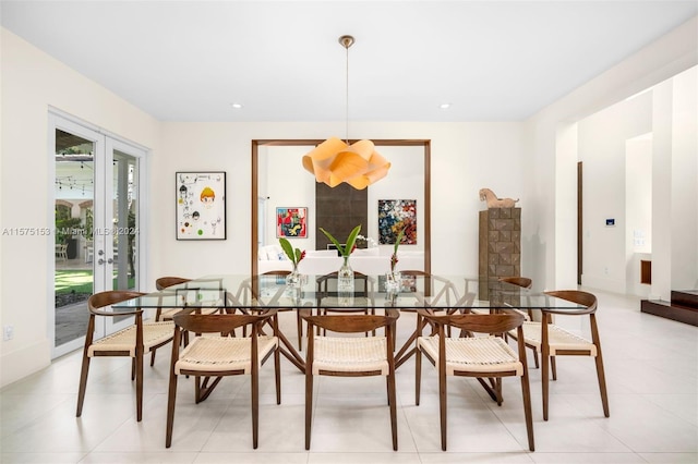 dining space featuring french doors and light tile floors