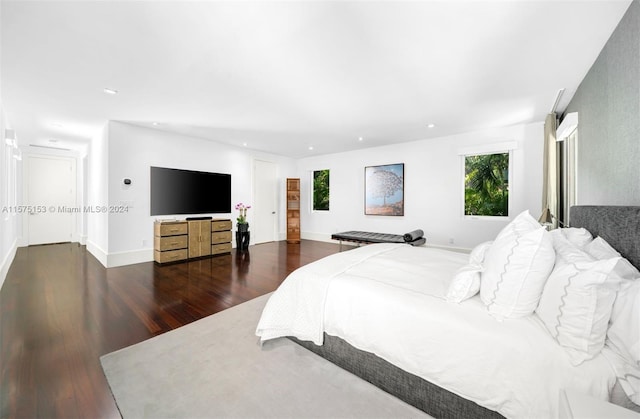 bedroom with dark hardwood / wood-style floors