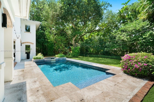 view of pool with a lawn and a patio