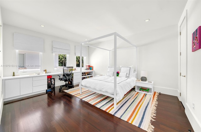 bedroom with dark hardwood / wood-style floors