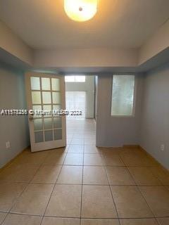 unfurnished room with light tile floors