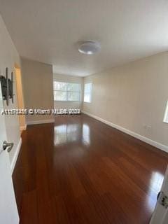 spare room featuring wood-type flooring