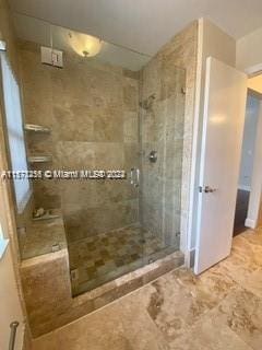 bathroom featuring walk in shower and tile flooring