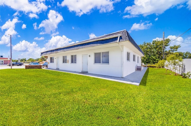 back of house featuring a patio, a yard, and central AC