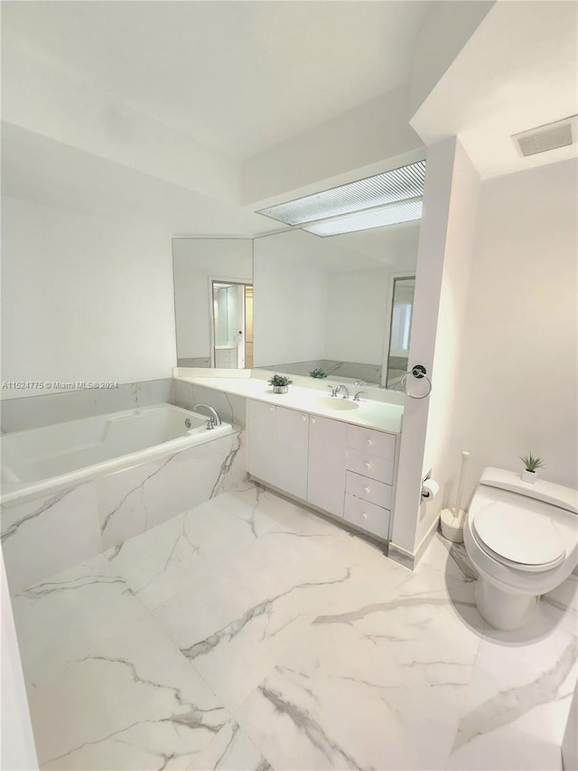 bathroom featuring oversized vanity, toilet, tile flooring, and a bath