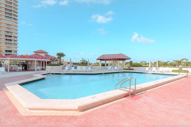 view of swimming pool featuring a patio area and a gazebo