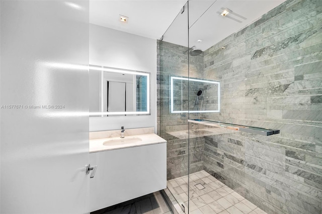 bathroom featuring vanity with extensive cabinet space, tile flooring, and walk in shower