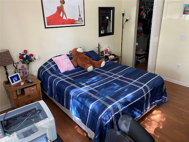 bedroom with hardwood / wood-style flooring and a closet