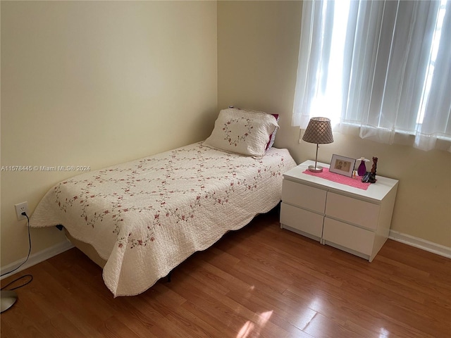 bedroom with hardwood / wood-style floors