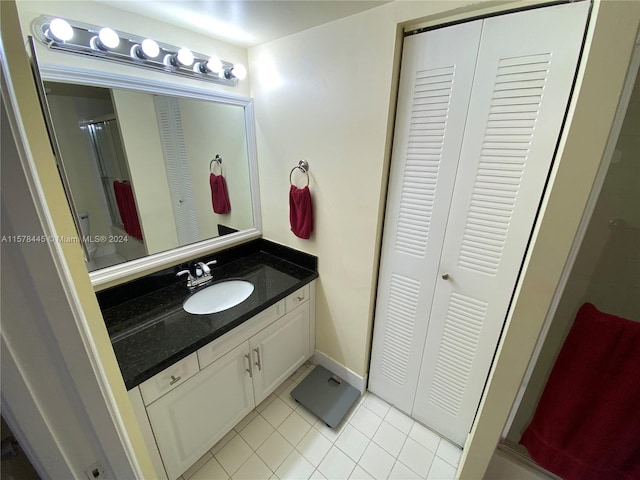 bathroom featuring tile patterned floors, walk in shower, and vanity