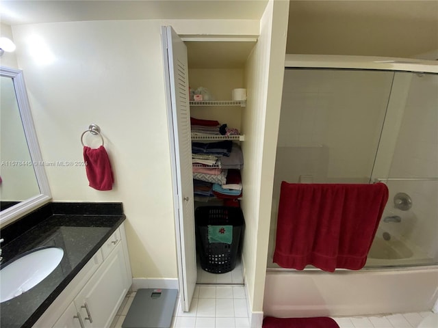 bathroom featuring shower / bath combination with glass door, vanity, and tile patterned floors