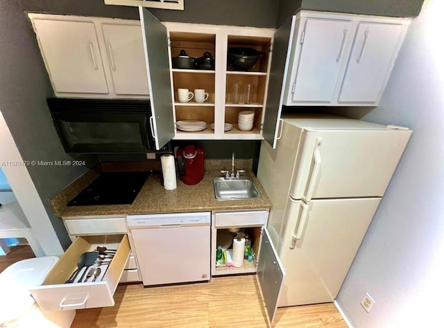 kitchen featuring light wood-type flooring, sink, white appliances, and white cabinetry