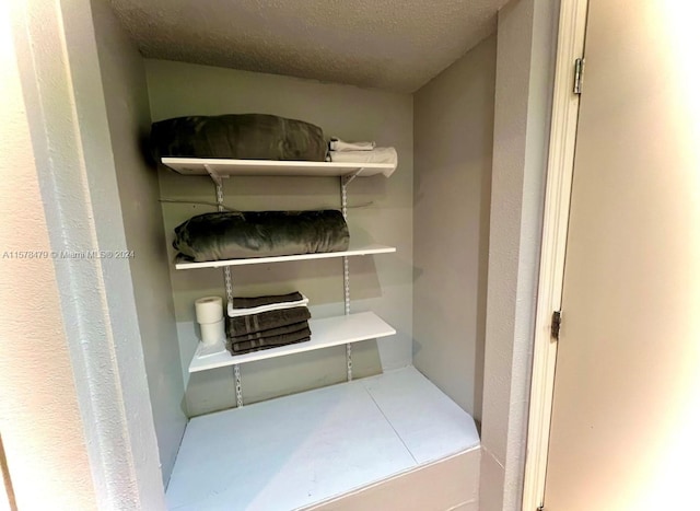 laundry room with a textured ceiling