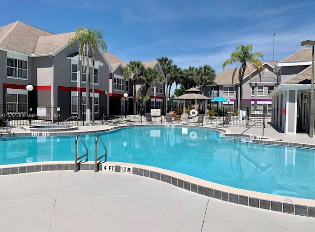 view of pool with a patio and a community hot tub