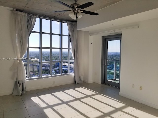 unfurnished room featuring ceiling fan and tile floors