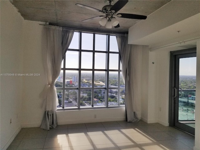 tiled empty room with ceiling fan