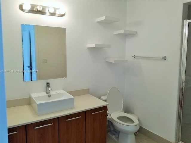 bathroom featuring walk in shower, tile flooring, vanity, and toilet