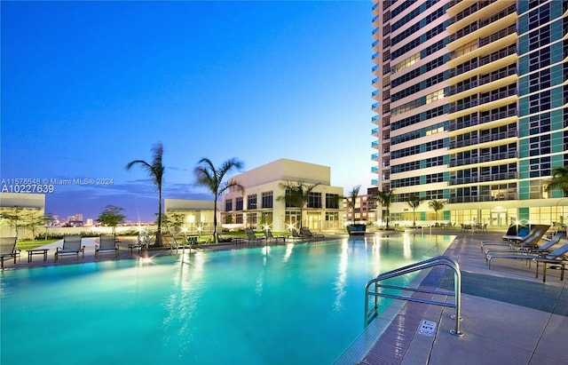 view of pool at dusk