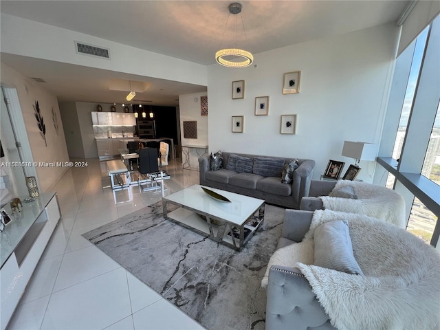 living room featuring expansive windows and tile patterned flooring