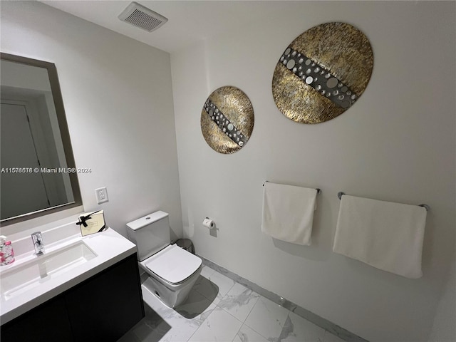 bathroom with tile patterned flooring, vanity, and toilet