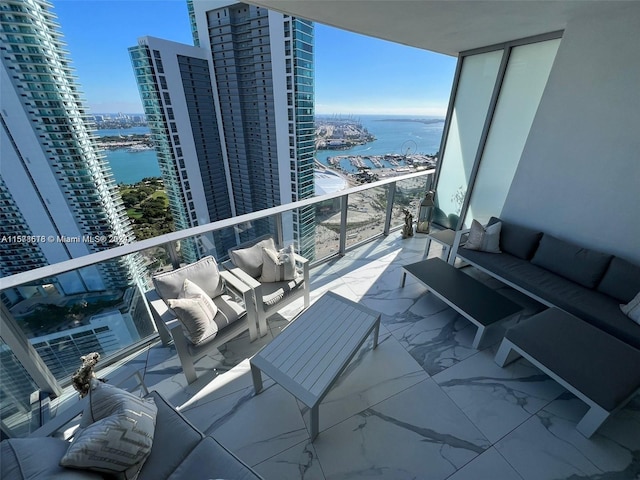 balcony featuring an outdoor hangout area and a water view