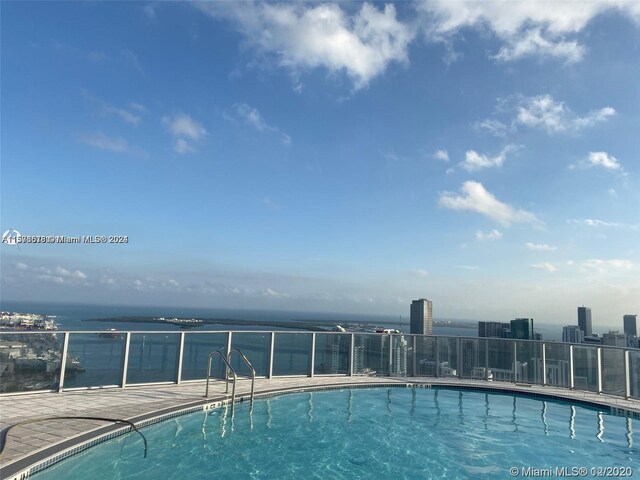 view of pool featuring a water view