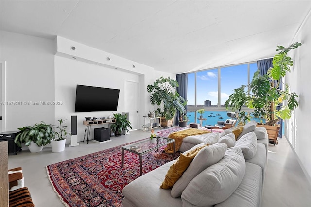 living room with concrete floors and a wall of windows