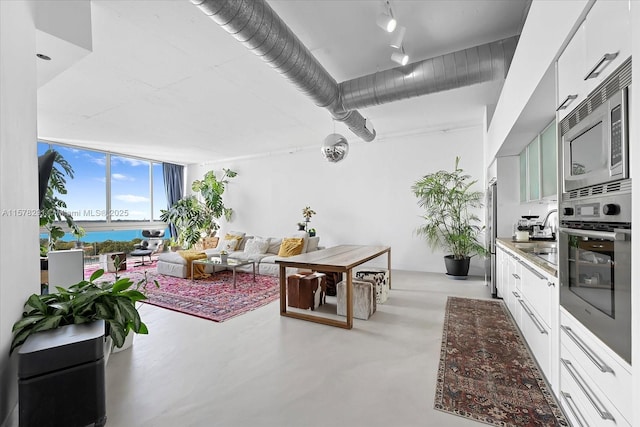 kitchen with white cabinets, appliances with stainless steel finishes, and a water view