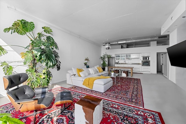 living room featuring concrete flooring