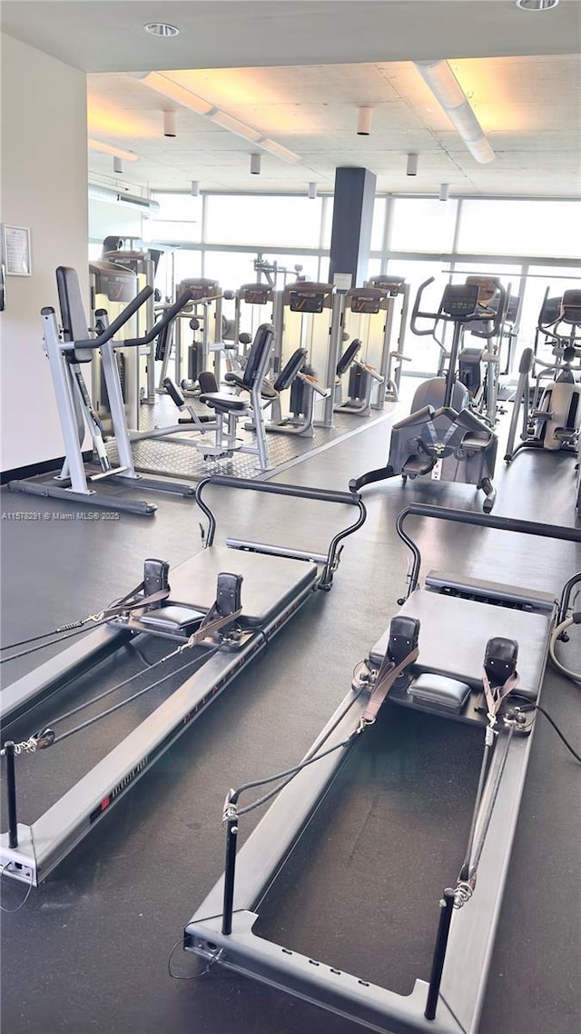 gym with a healthy amount of sunlight and a wall of windows