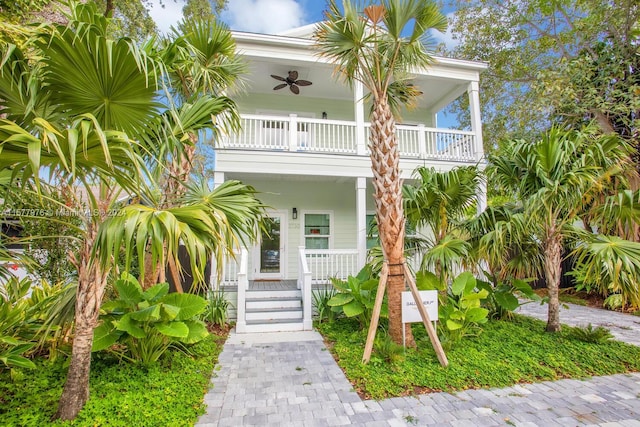 view of front of house with ceiling fan, a porch, and a balcony