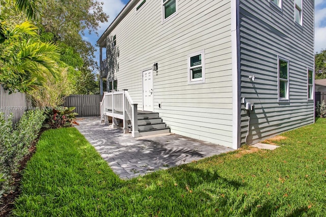 back of house featuring a yard and a patio area